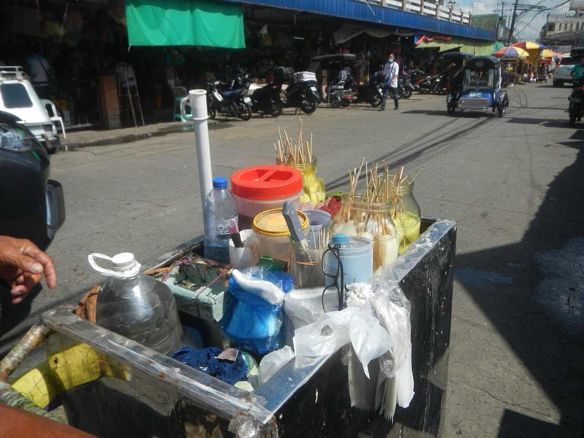 Filipino street vendor with food cart