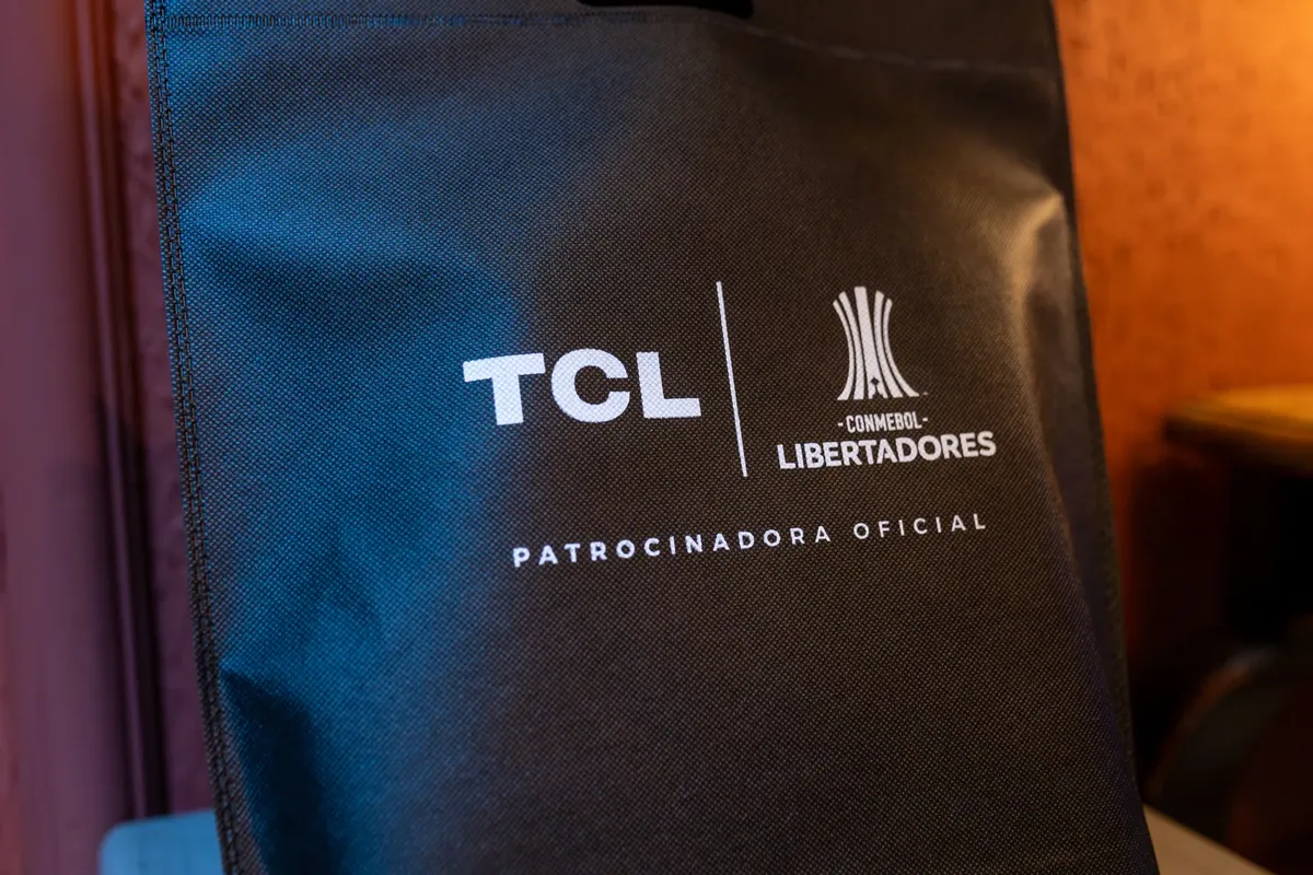 Close-up of a black sponsorship bag showing TCL and CONMEBOL Libertadores logos with brand details.