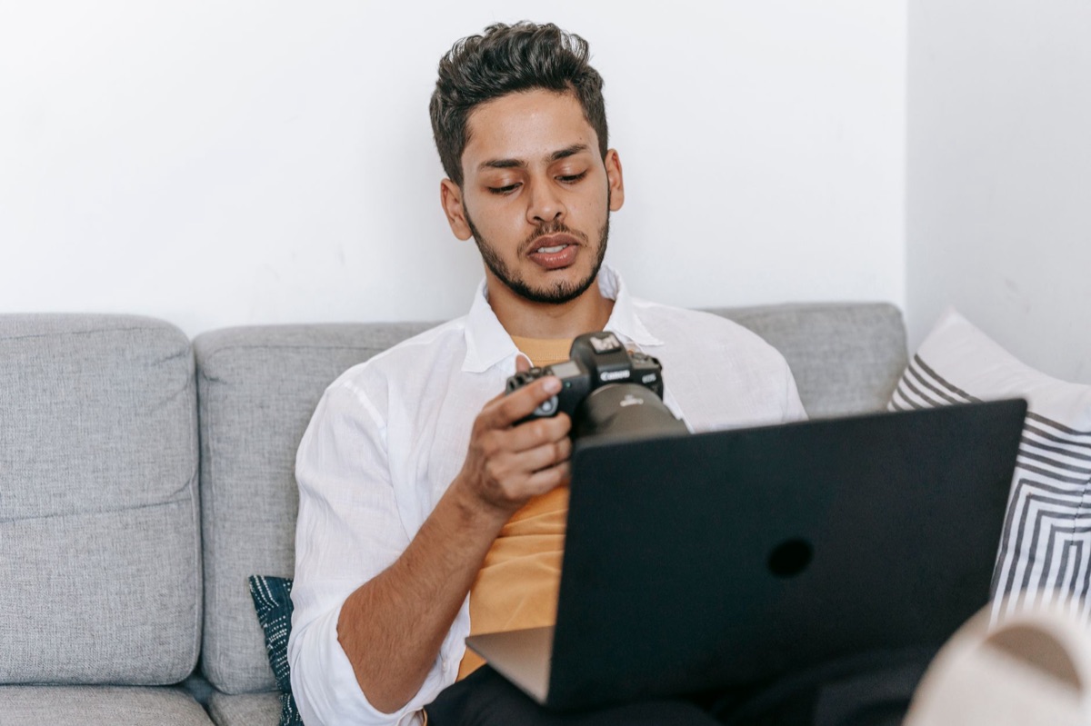 Filipino YouTuber with camera and laptop