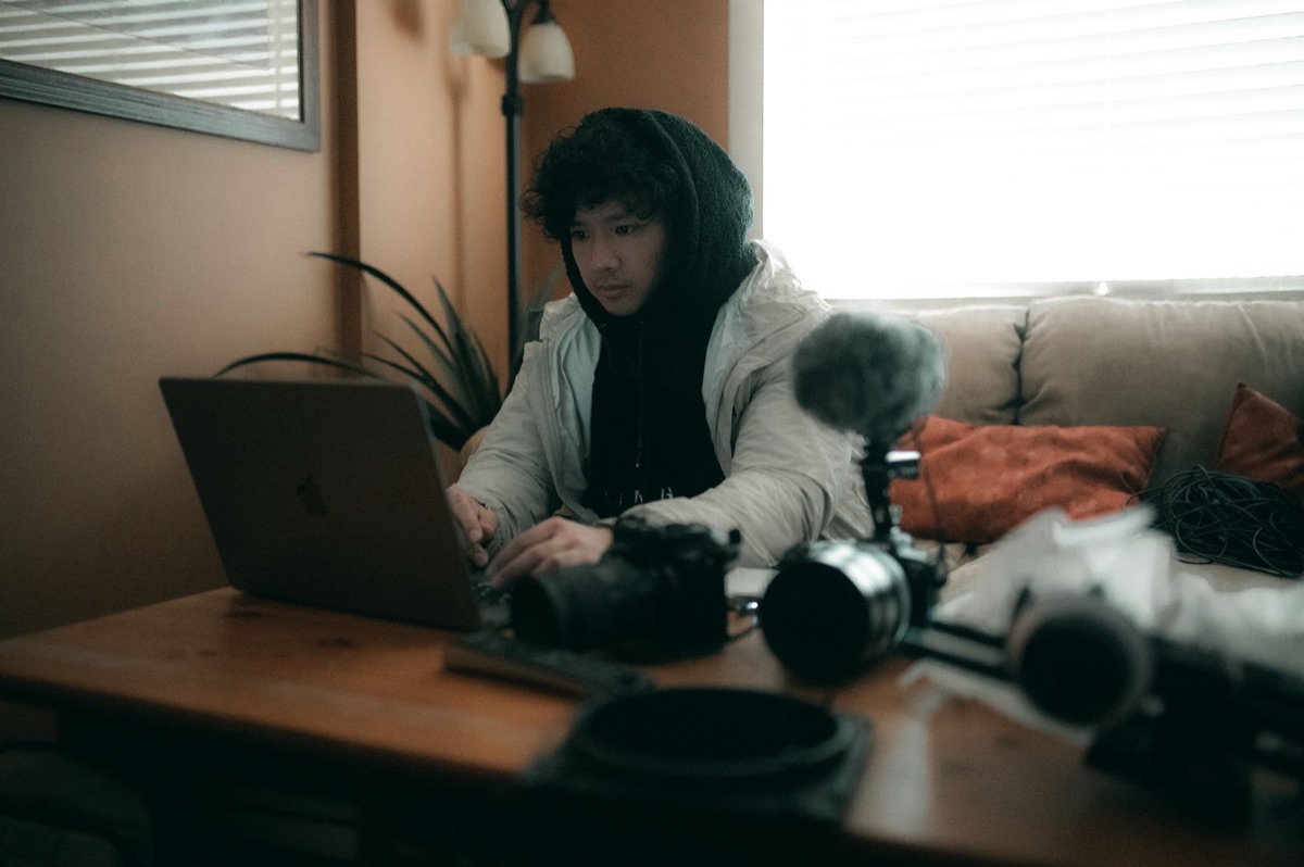 Filipino You-tuber with laptop and camera